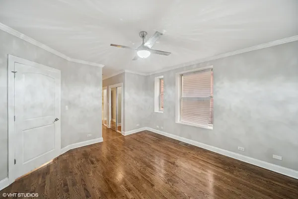 a view of empty room with window and ceiling fan