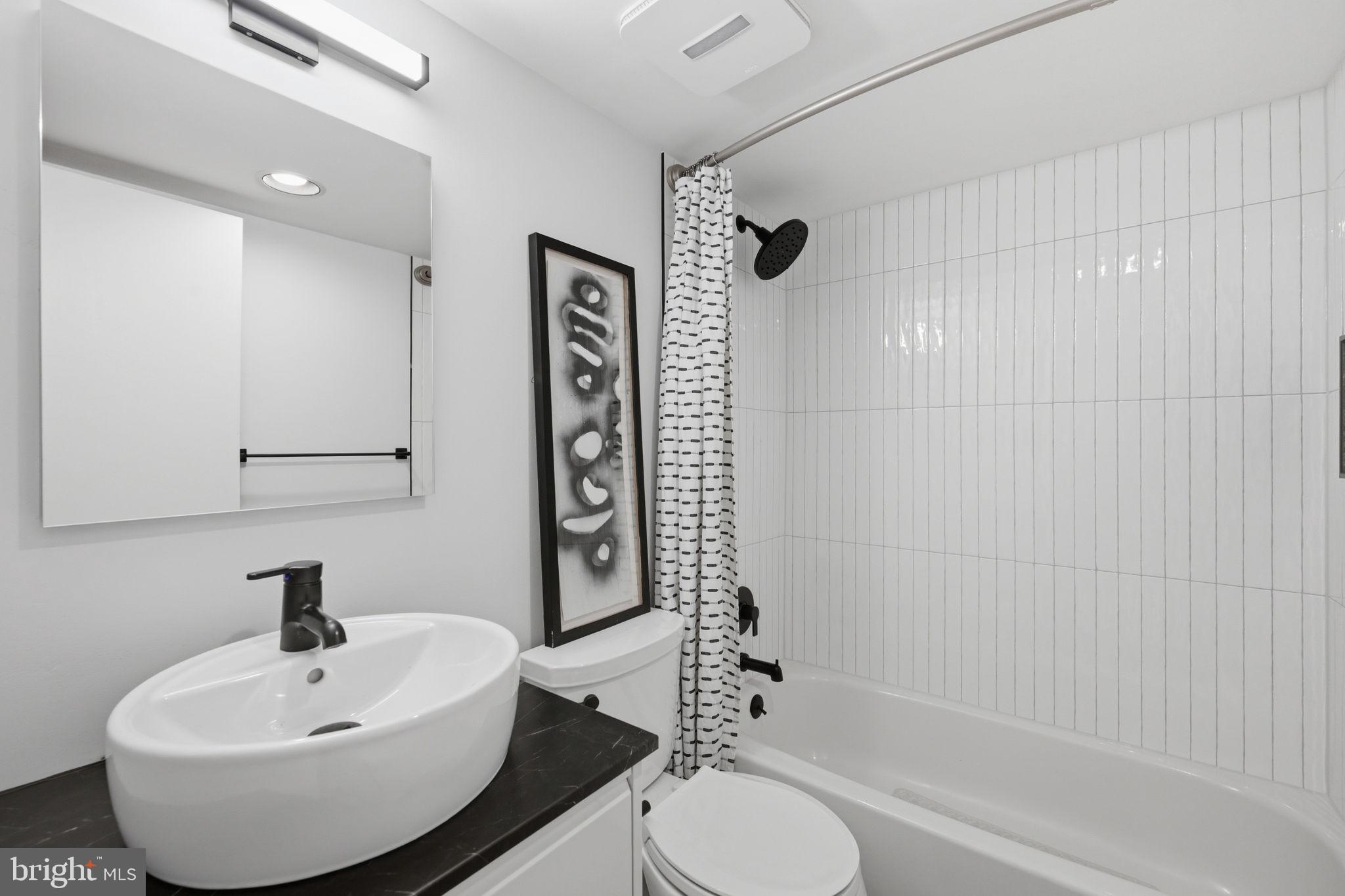2829 29th Place Northwest Washington, DC 20008 - Photo 33 of 41 a bathroom with a sink a toilet and shower