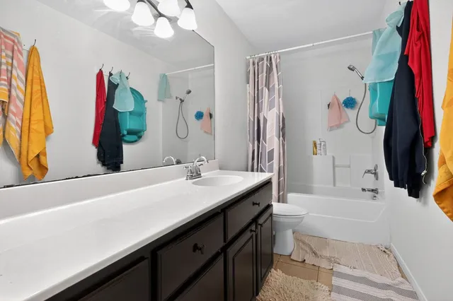 a bathroom with a tub sink and a mirror
