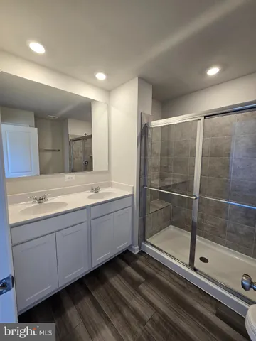 a bathroom with a double vanity sink and mirror
