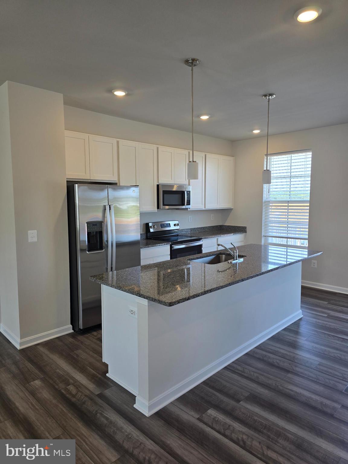 103 Winterplace Drive Charles Town, WV 25414 - Photo 3 of 20 a kitchen with stainless steel appliances granite countertop a refrigerator a stove a sink and a microwave