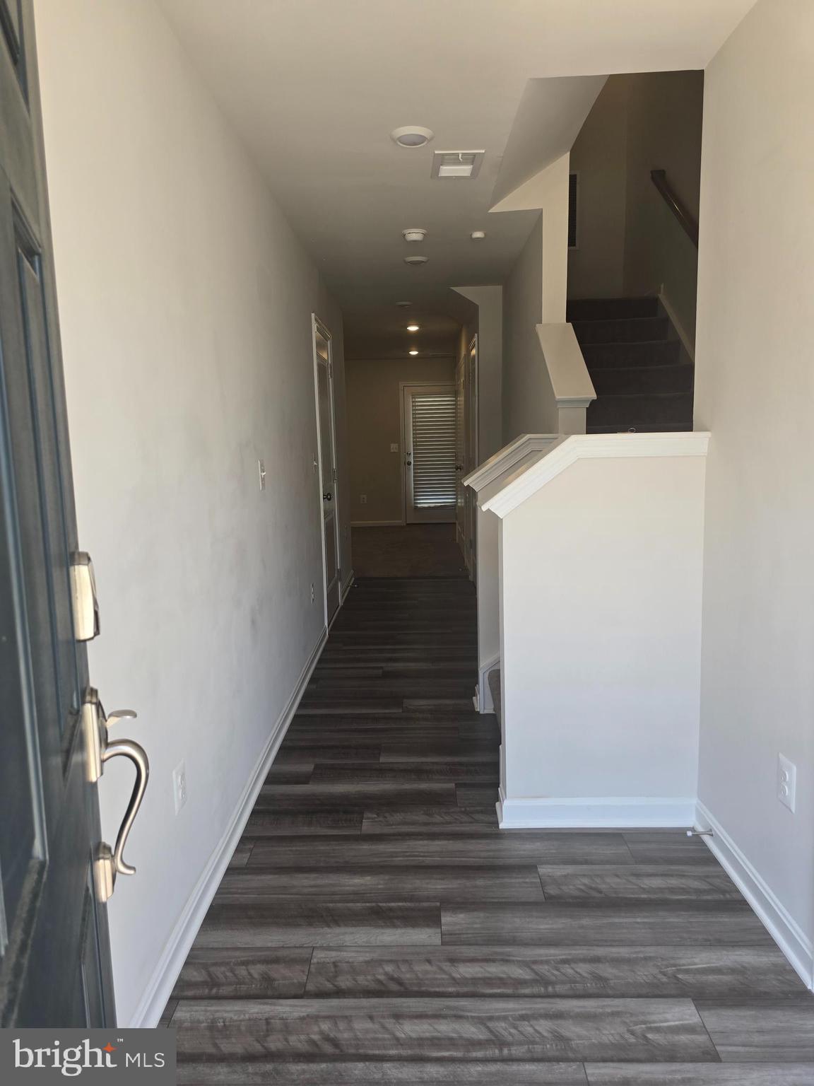 103 Winterplace Drive Charles Town, WV 25414 - Photo 7 of 20 a view of a hallway with wooden floor and staircase