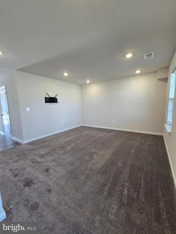 an empty room with a empty space and windows