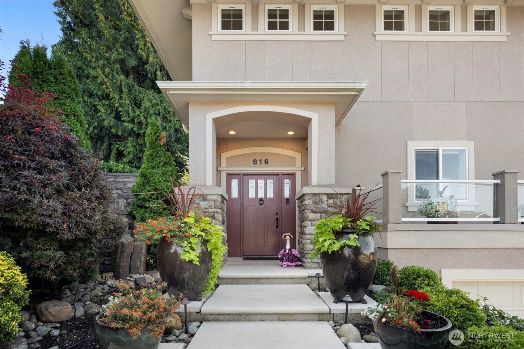 a front view of a house with lots of potted plants