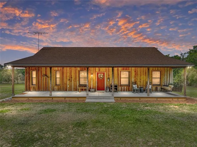 a front view of house with yard and porch