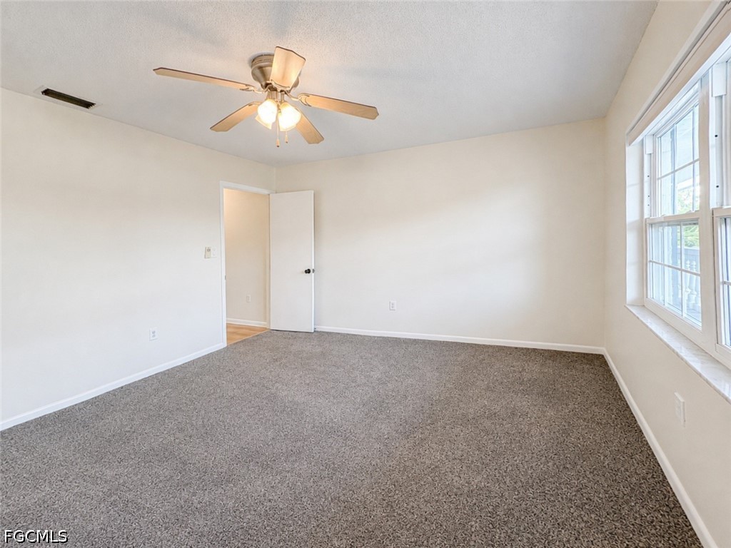 1830 Brantley Road, Unit I7 Fort Myers, FL 33907 - Photo 21 of 34 a view of an empty room with a window