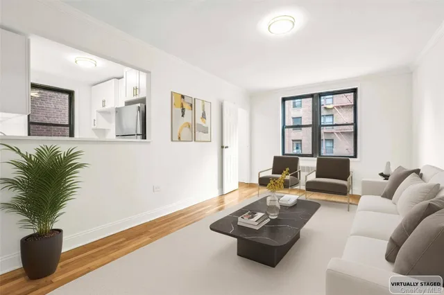 a living room with furniture potted plant and a window