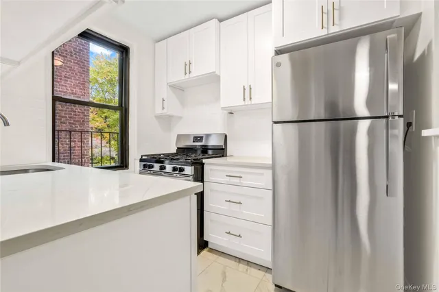 a kitchen with appliances cabinets and a window