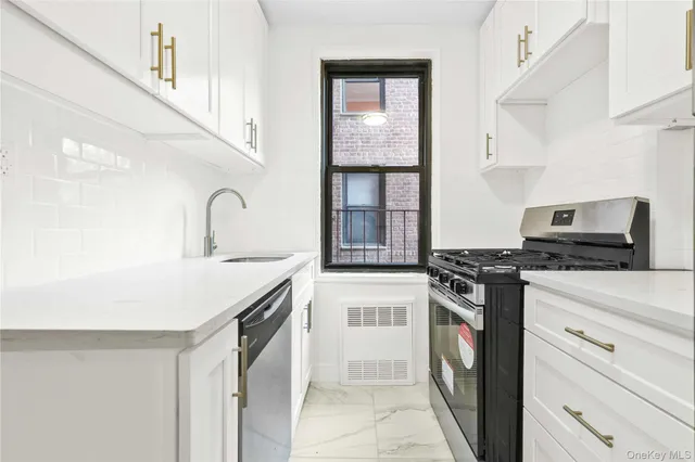 a kitchen with stainless steel appliances granite countertop a stove and a sink