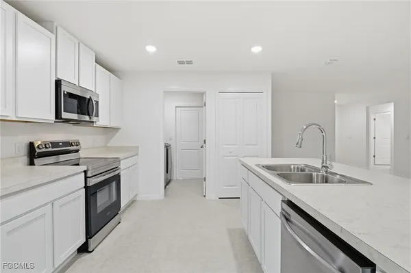a kitchen that has a sink and a stove