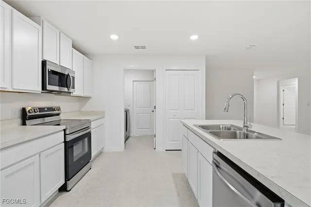 a kitchen that has a sink and a stove