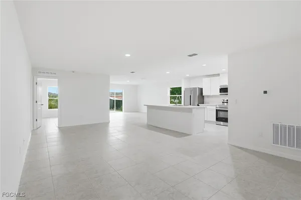 a view of a kitchen with furniture and wooden floor