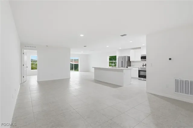 a view of a kitchen with furniture and wooden floor