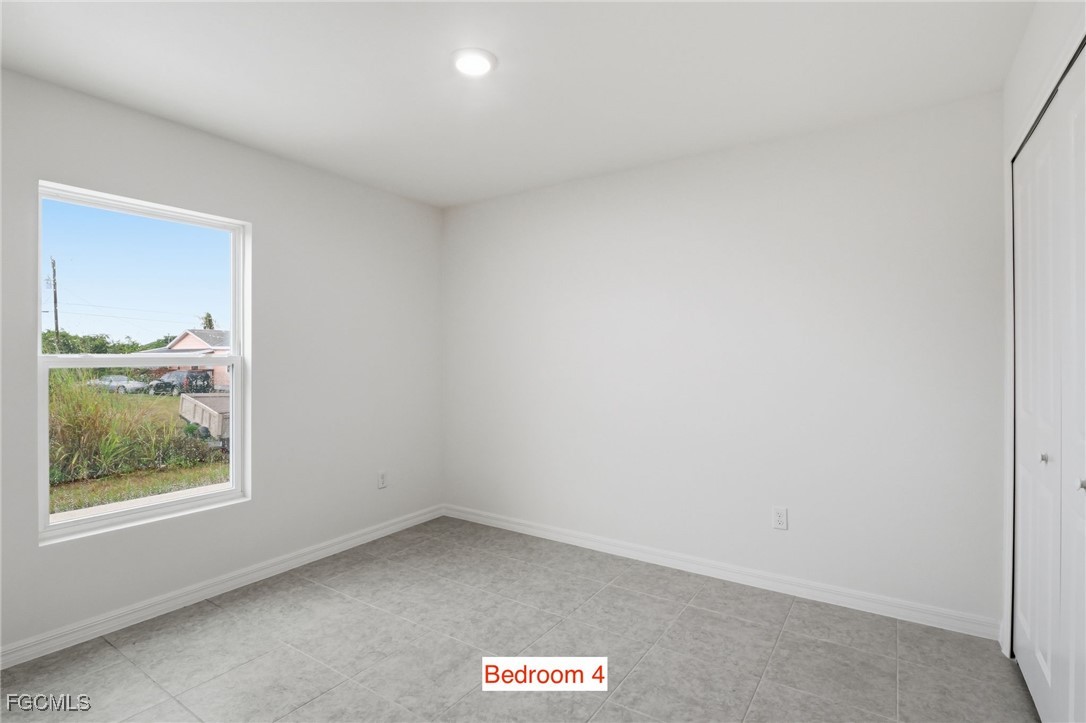3418 20th Street Southwest Lehigh Acres, FL 33976 - Photo 30 of 34 a view of an empty room and window