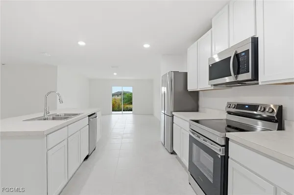 a kitchen with stainless steel appliances granite countertop a sink and a stove