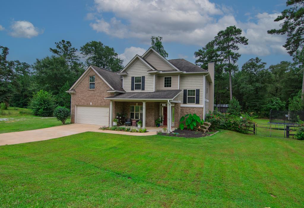 a front view of a house with a yard and garage
