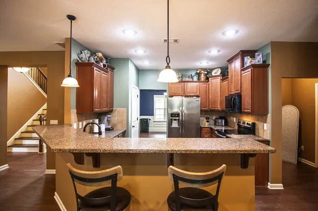 a view of a dining room with furniture a chandelier and wooden floor