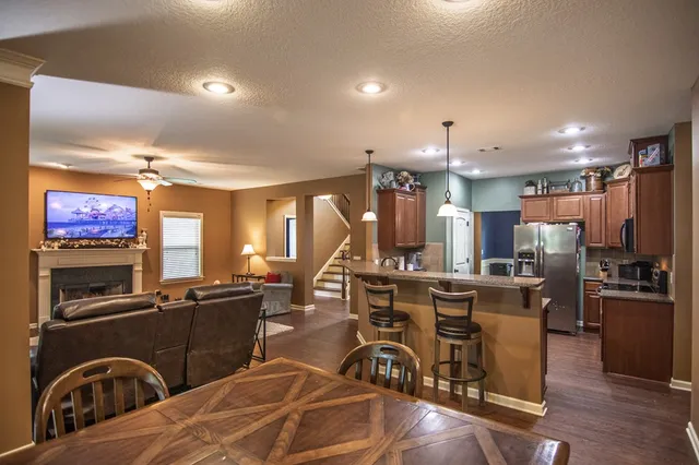 a spacious bedroom with a bed and a chandelier