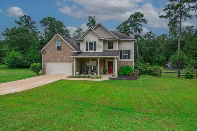 a front view of a house with a yard