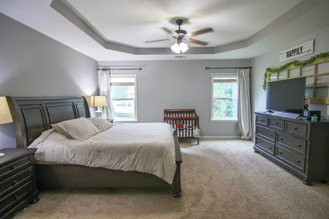 a view of a livingroom with a ceiling fan and window