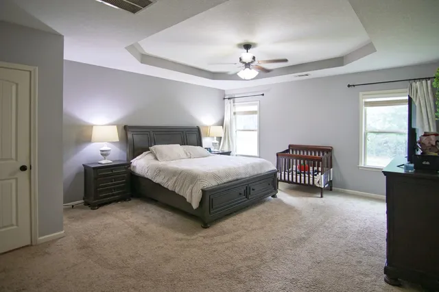 a view of a livingroom with a ceiling fan and window