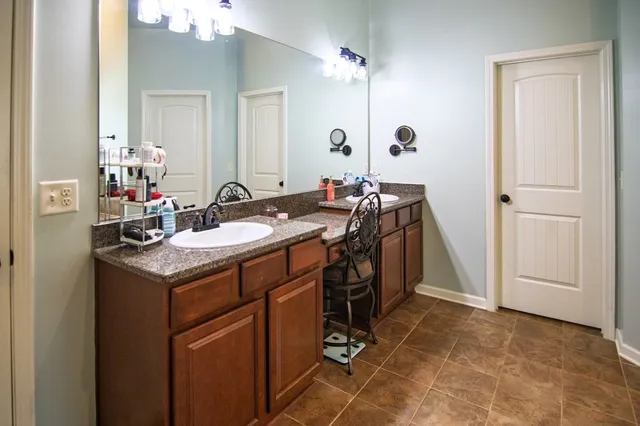 a view of a house with a big yard and large trees