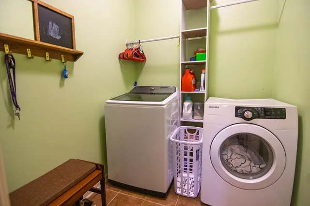 a view of a house with a big yard and large trees
