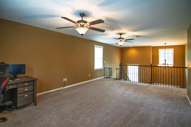 a backyard of a house with barbeque oven and trees