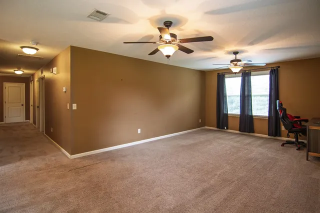 a front view of a house with a yard and trees