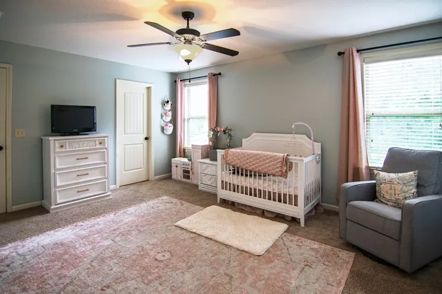 an aerial view of a house with outdoor space and swimming pool