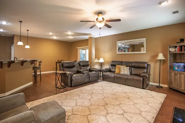 a kitchen with stainless steel appliances granite countertop a sink a stove and a wooden floors