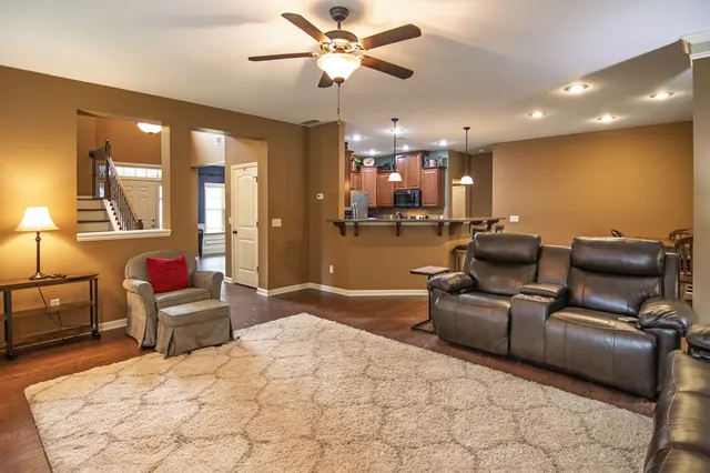 a kitchen with kitchen island granite countertop a sink stainless steel appliances and cabinets