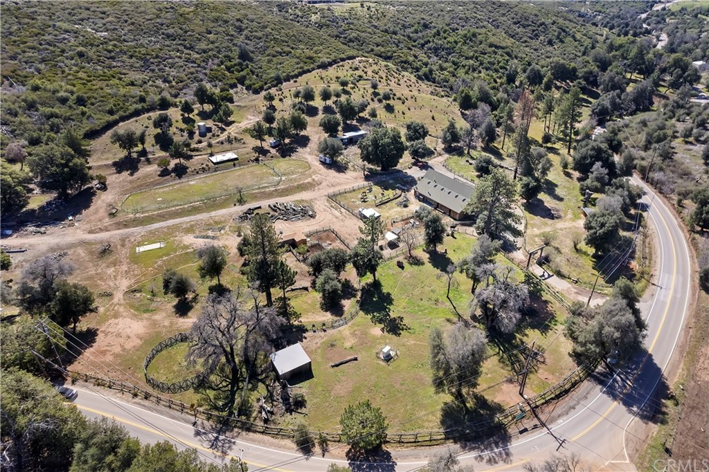 an aerial view of a house with a yard and parking space