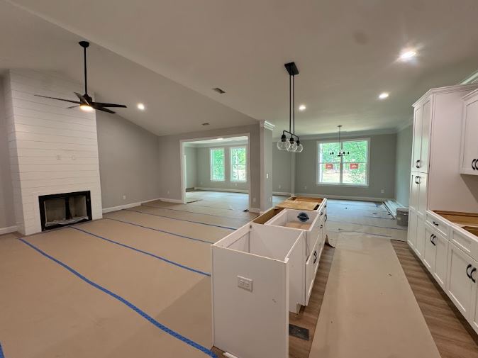 513 Quail Hollow Road Anderson, SC 29621 - Photo 13 of 39 This expansive open concept space features a cozy fireplace, vaulted ceilings, and ample natural light.