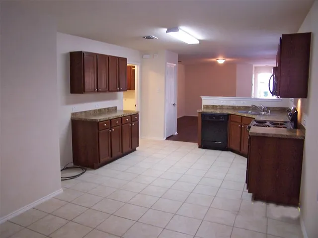 a kitchen with stainless steel appliances granite countertop a stove and a sink