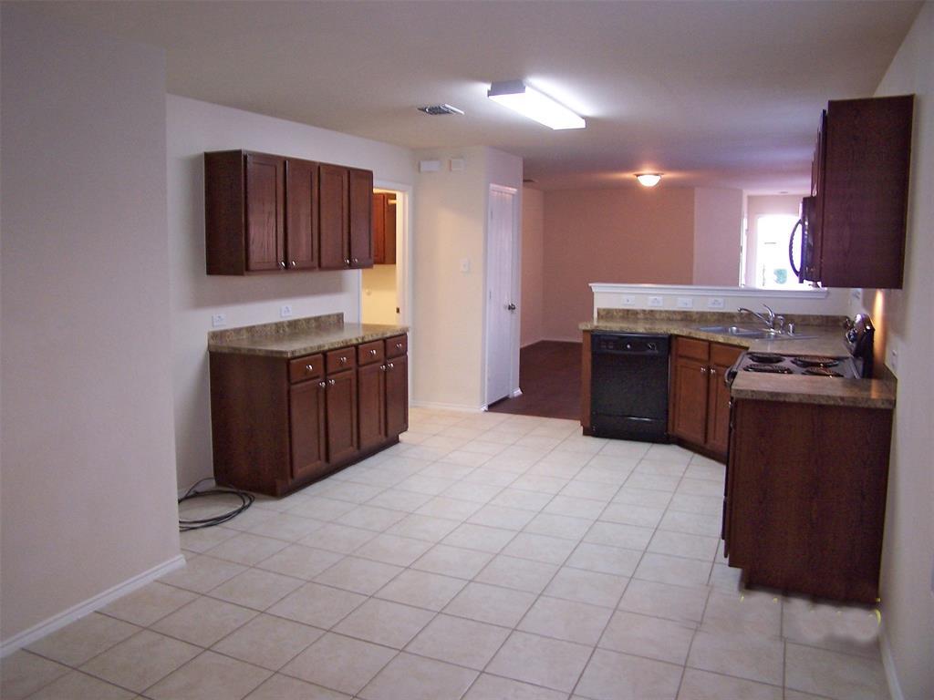 8844 Valley River Drive Fort Worth, TX 76244 - Photo 2 of 13 a kitchen with stainless steel appliances granite countertop a stove and a sink