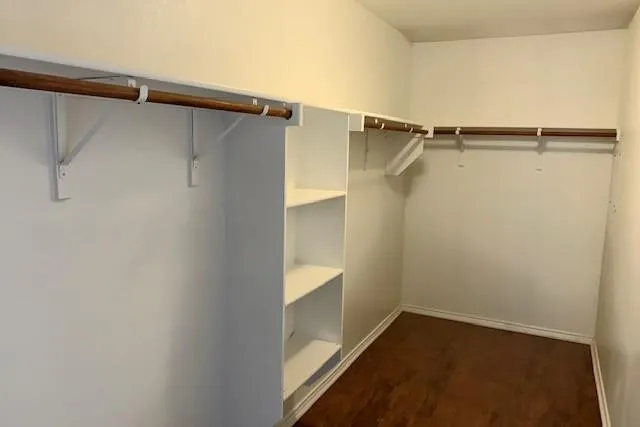 a view of walk in closet with empty racks