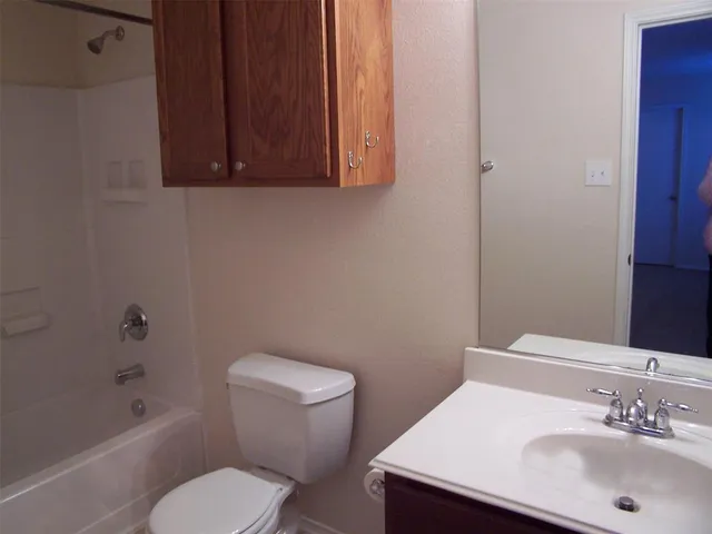 a bathroom with a sink a toilet and bathtub