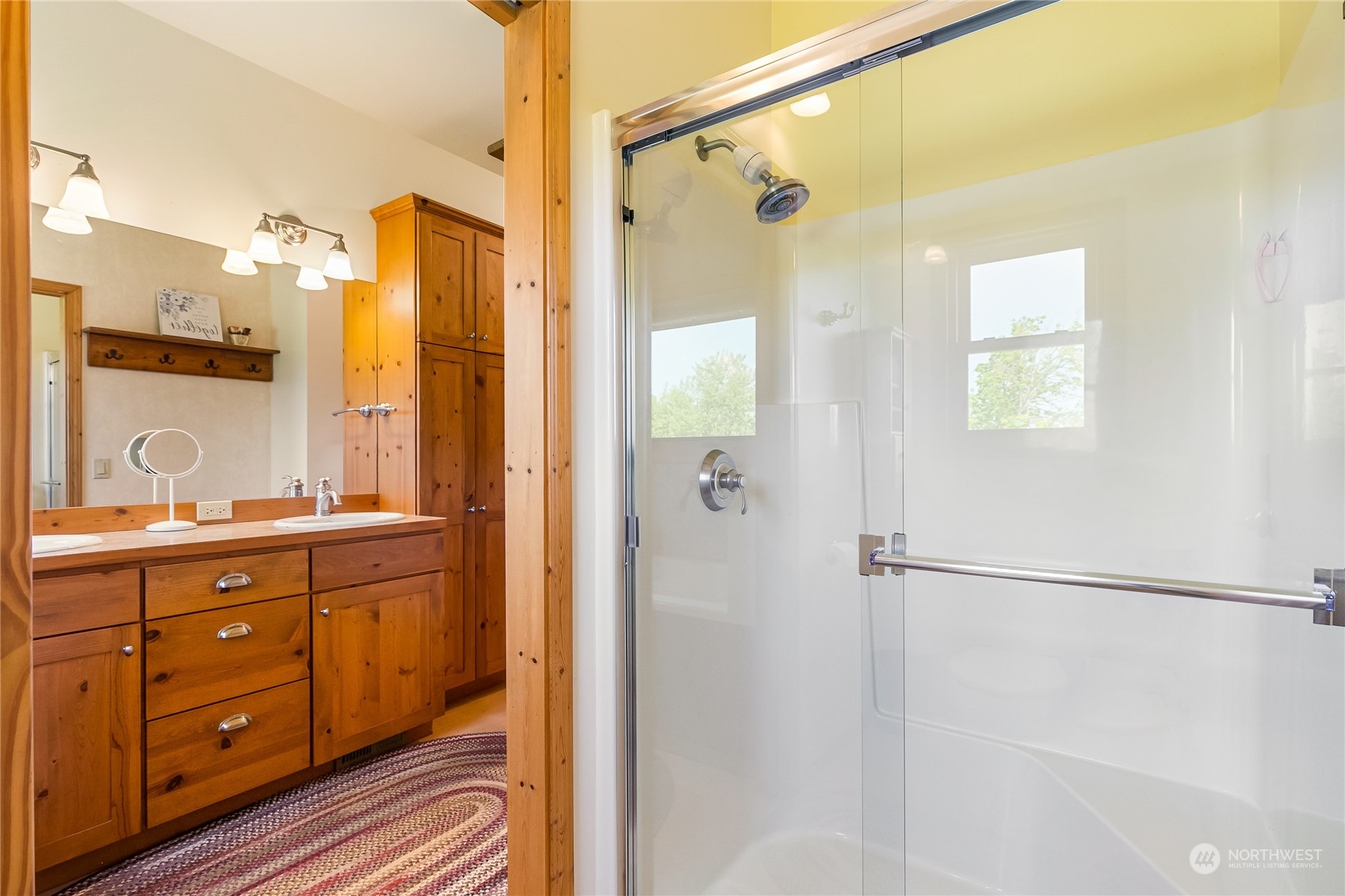 852 Lange Road Bellingham, WA 98226 - Photo 16 of 40 a bathroom with a double vanity sink a mirror a shower and a glass door