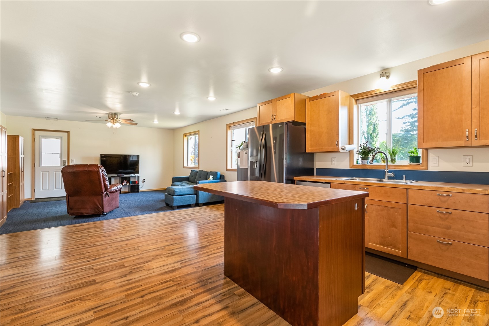 852 Lange Road Bellingham, WA 98226 - Photo 27 of 40 a large living room with stainless steel appliances granite countertop a couch a dining table and chairs in it