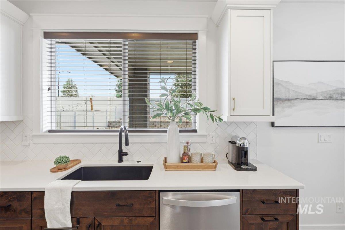 5897 West Riva Capri Street Meridian, ID 83646 - Photo 6 of 50 Kitchen sink area featuring a black basin, a matte black gooseneck faucet, and white quartz countertops