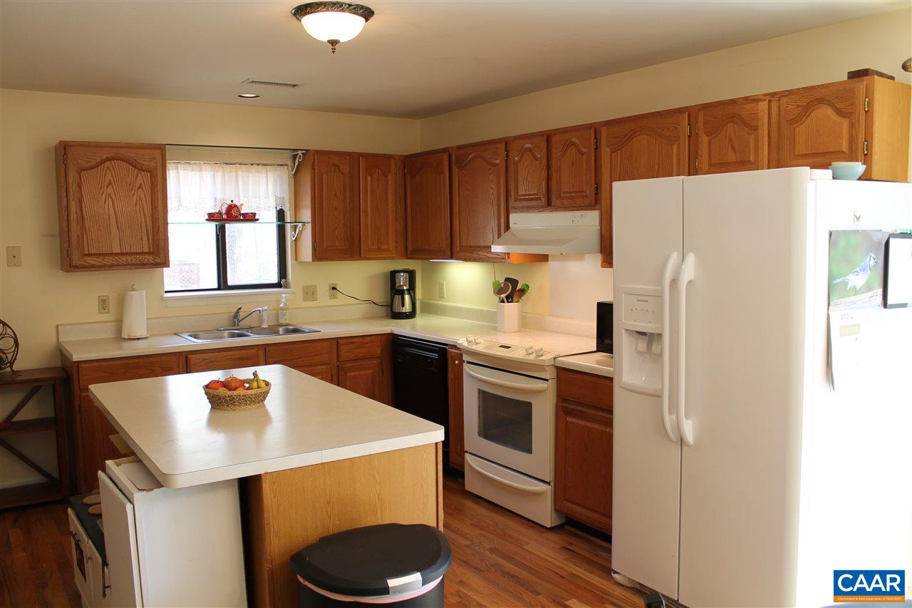 11 Dogleg Road Palmyra, VA 22963 - Photo 5 of 28 a kitchen with a refrigerator a sink and wooden cabinets
