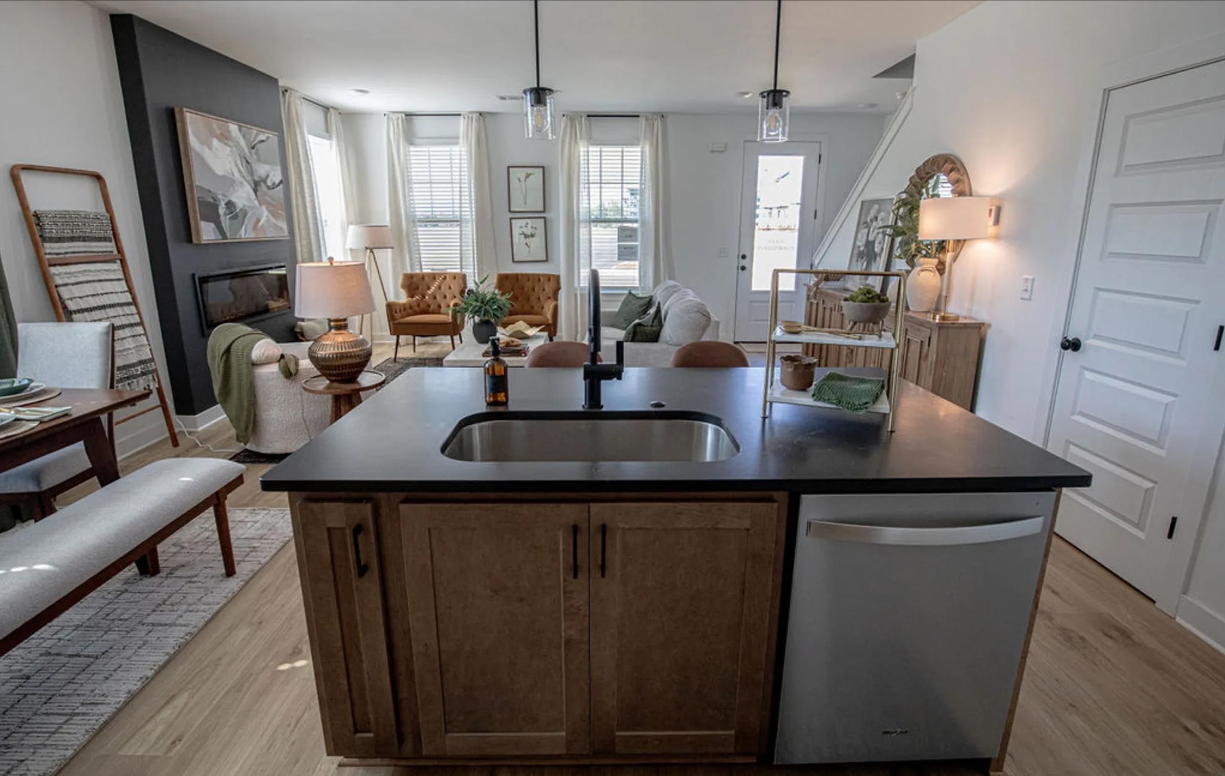 6888 Talcott Lane Bartlett, TN 38135 - Photo 17 of 19 Kitchen featuring an island with sink, dishwasher, open floor plan, and light wood-style flooring