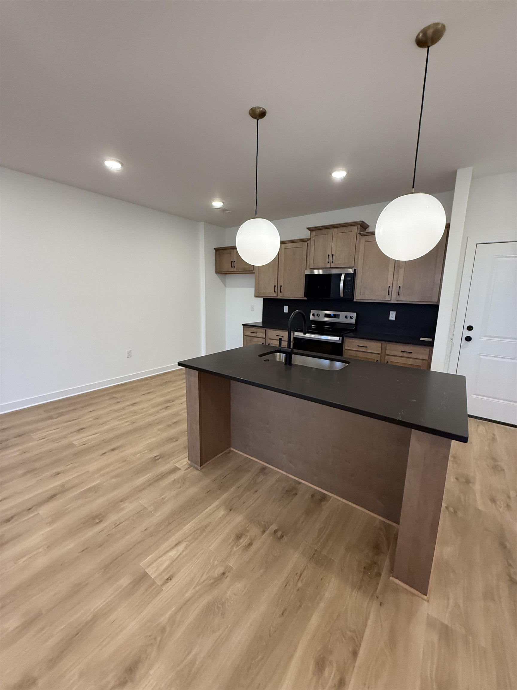 6888 Talcott Lane Bartlett, TN 38135 - Photo 5 of 16 a view of a room with a chandelier and wooden floor