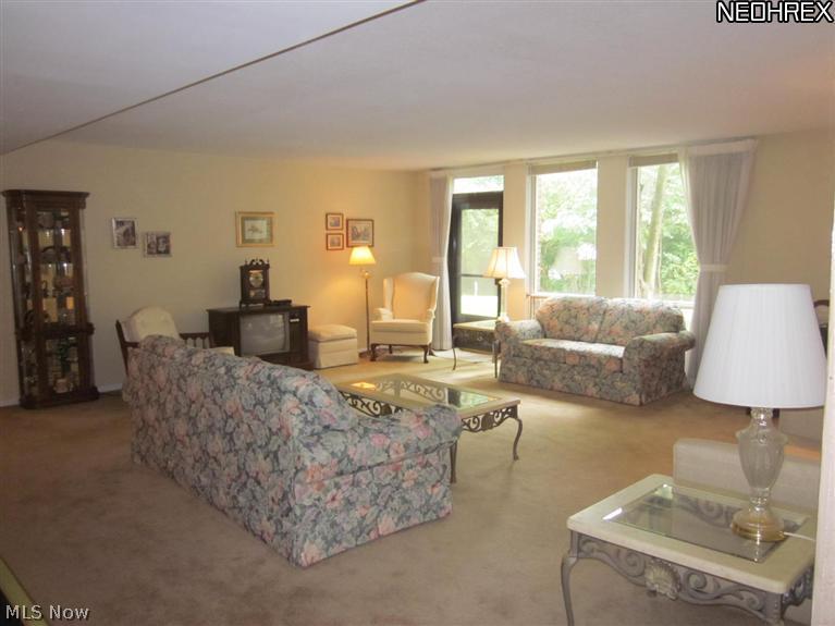 2365 Covington Road, Unit 122E Akron, OH 44313 - Photo 2 of 23 living room with door leading to private setting to the outdoors.