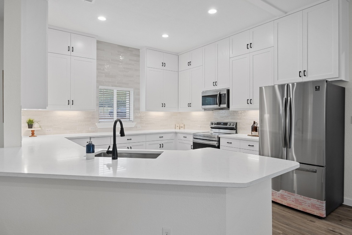 17701 Village Drive Dripping Springs, TX 78620 - Photo 1 of 36 a kitchen with refrigerator and a sink