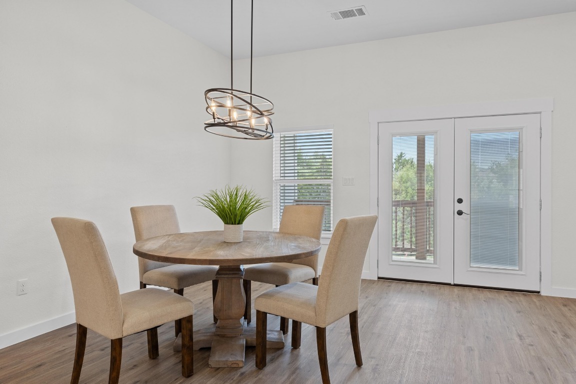 17701 Village Drive Dripping Springs, TX 78620 - Photo 14 of 36 a view of a dining room with furniture window and wooden floor