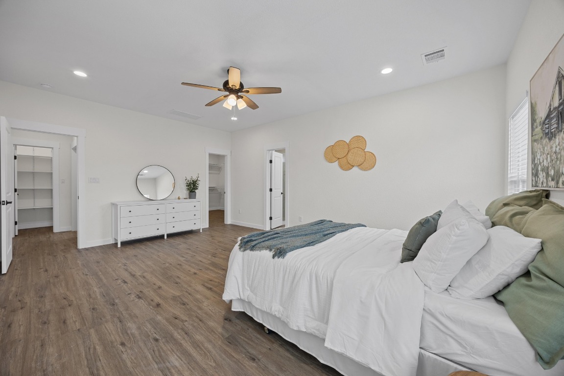 17701 Village Drive Dripping Springs, TX 78620 - Photo 17 of 36 a bedroom with a bed and a chandelier