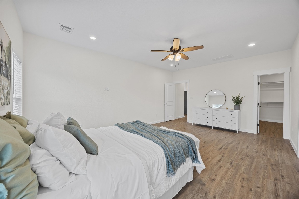 17701 Village Drive Dripping Springs, TX 78620 - Photo 18 of 36 a bedroom with a bed and a chandelier