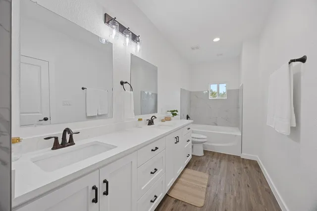 a bathroom with a sink a toilet and bathtub
